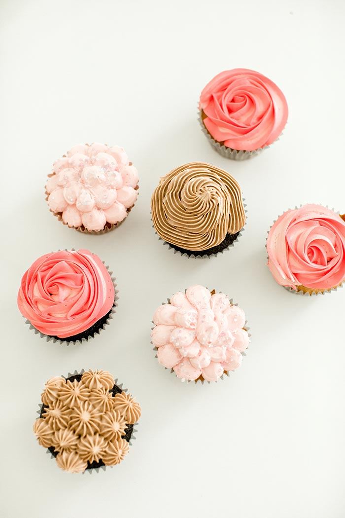 Rosette cupcakes piped in pink and cocoa